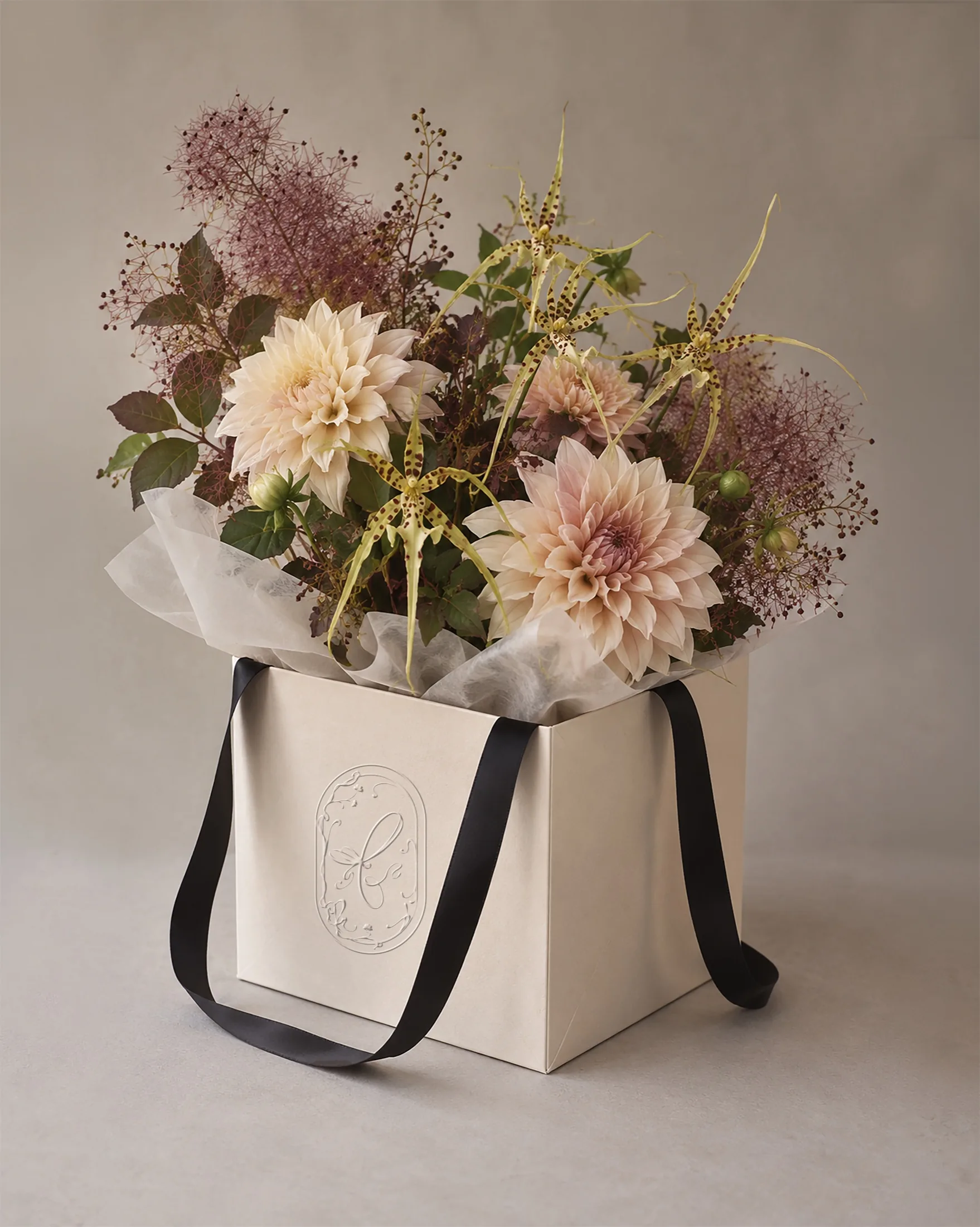A finished Flower Bar bouquet in its ribboned box packaging