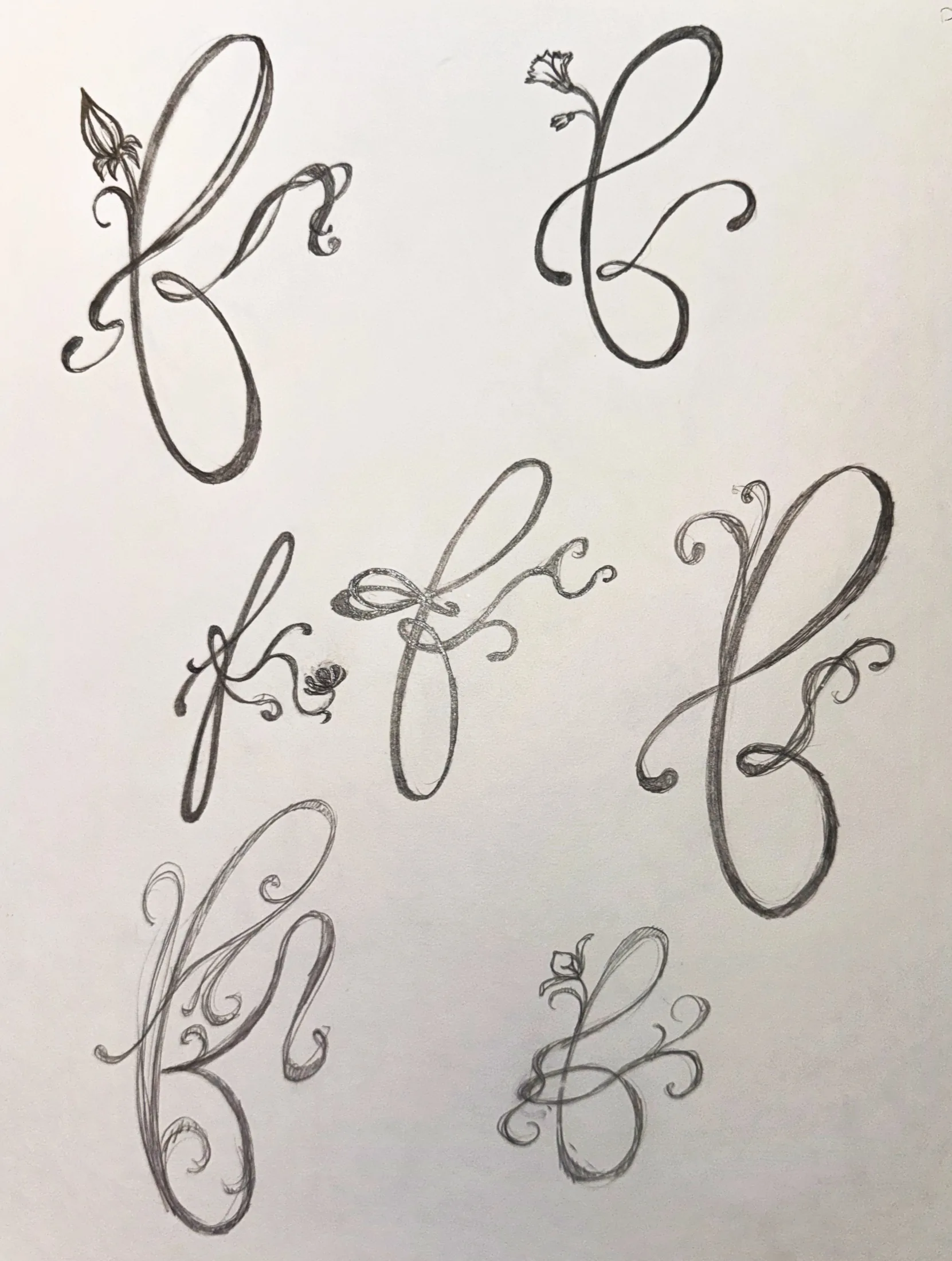 Sketchbook page refining the final cursive icon mark