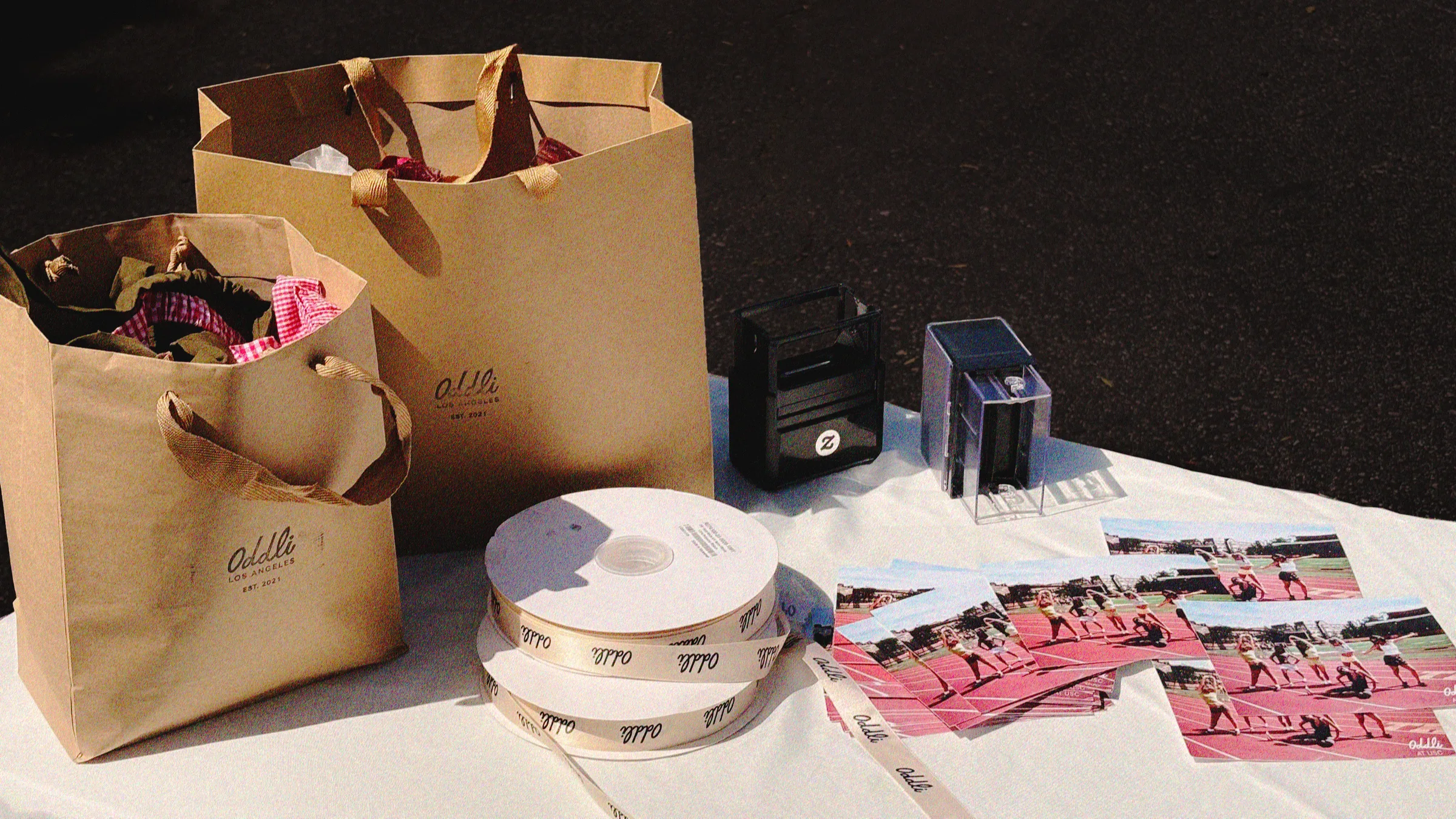 Oddli shopping bags and printed photos on the table