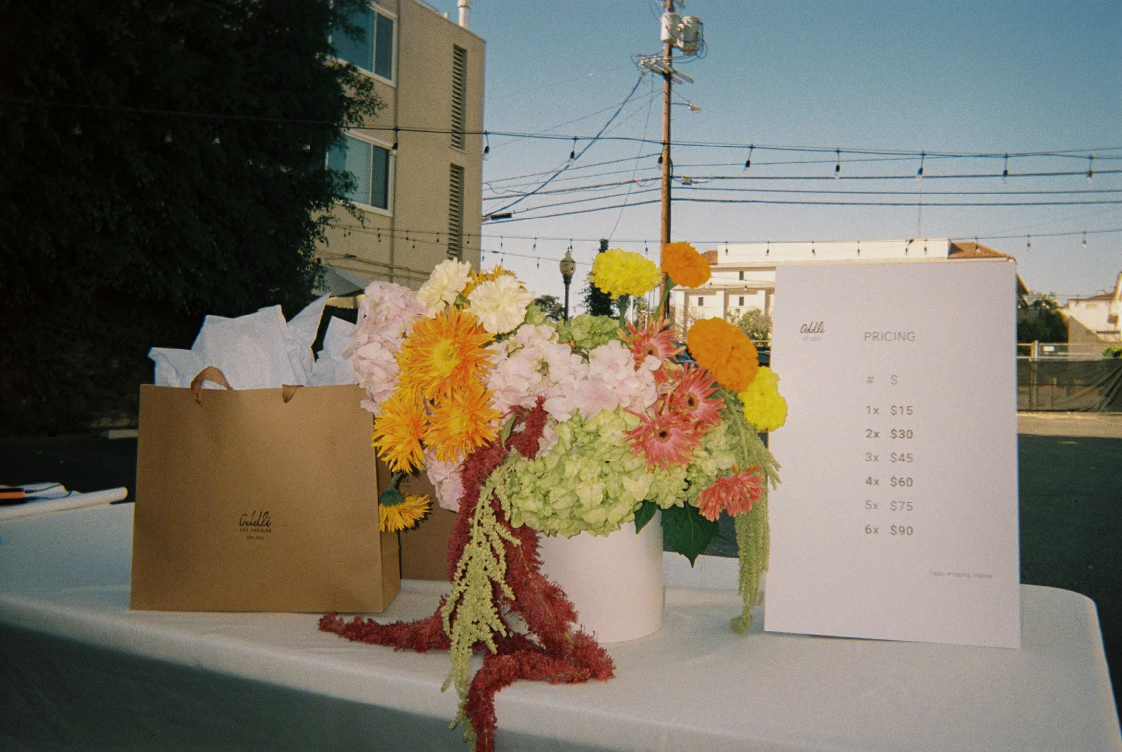 Flowers and the Oddli pricing sign on the table
